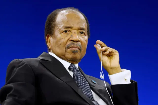 Cameroonian President Paul Biya wearing an interpretation earpiece
