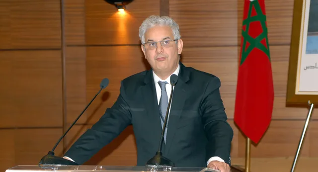 Nizar Baraka speaking at a lectern in front of the Moroccan flag, file photo