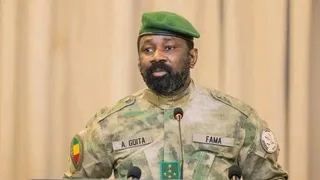 General Assimi Goïta in military uniform and green beret at a microphone, file photo