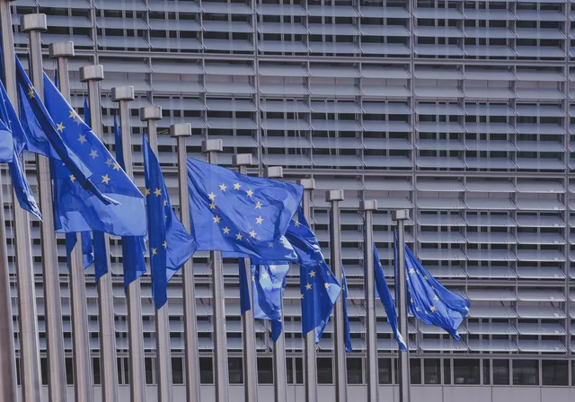 European Union flags flying in front of the European Commission building