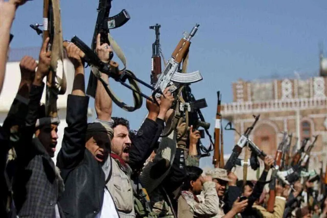 Armed men raising their rifles at a rally of Houthi supporters in Sanaa, file photo