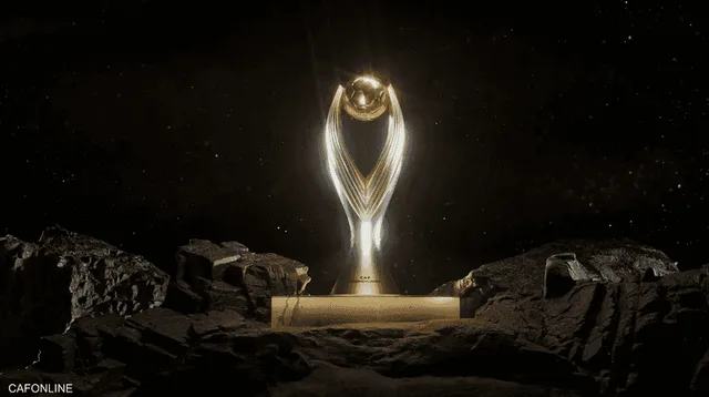 The new golden CAF Champions League trophy on a plinth among rocks against a dark background, file photo