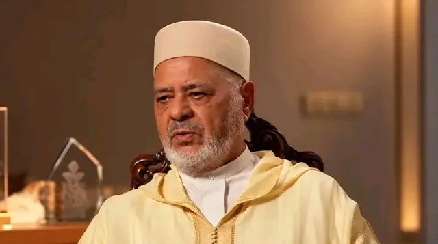 Ahmed Raissouni seated, wearing a white cap