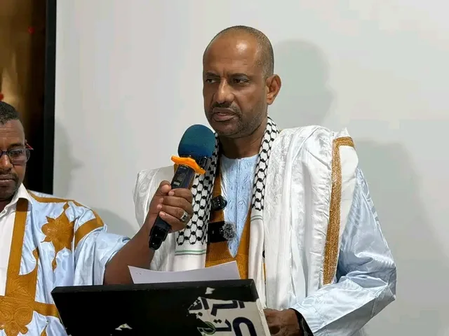 An official of the Unity and Development party speaks into a microphone at an event, file photo