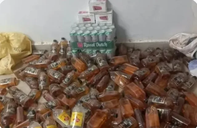 Bottles of seized alcoholic drinks on the floor