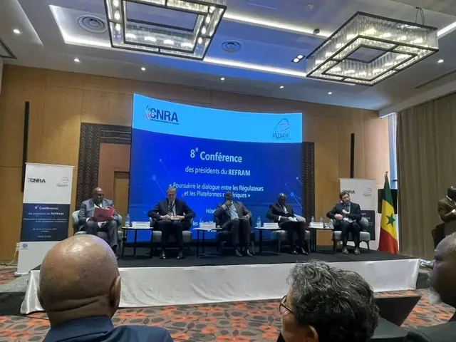 Five officials seated on a conference stage in front of a screen announcing the 8th conference of REFRAM presidents, file photo