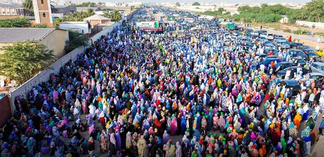 A large crowd at a political rally on a street in Nouakchott
