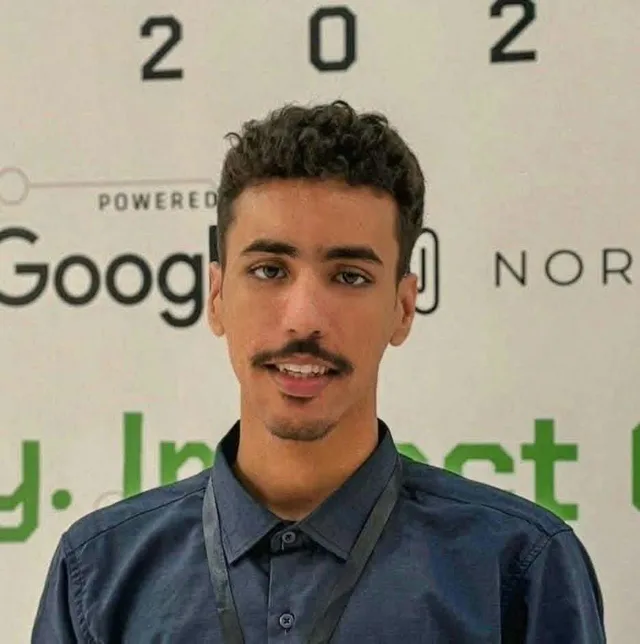 Portrait of a young man in front of an event backdrop