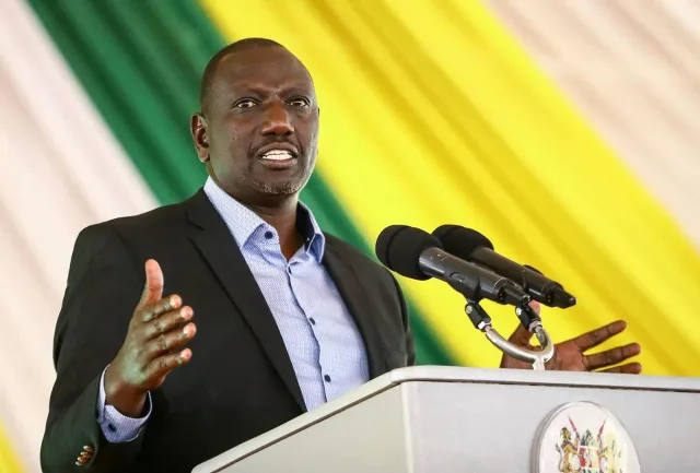 Kenyan President William Ruto speaking at a lectern against a backdrop in the colours of the Kenyan flag, file photo