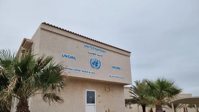 Building bearing the United Nations emblem and the name of its support mission in Libya, surrounded by palm trees, file photo