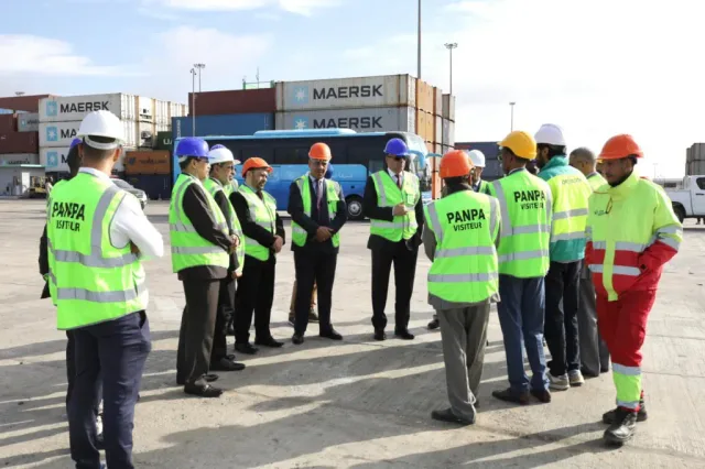 Visitors in high-visibility vests in the container yard of the Port of Nouakchott