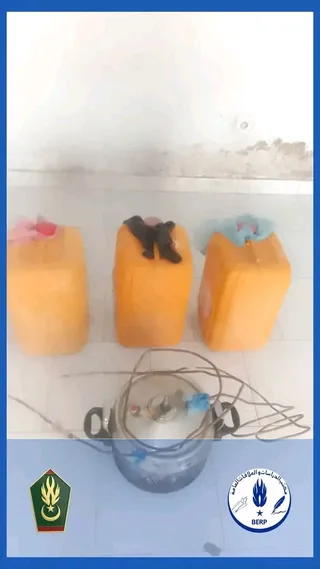 Three yellow jerrycans and a pot connected to tubing seized by the gendarmerie