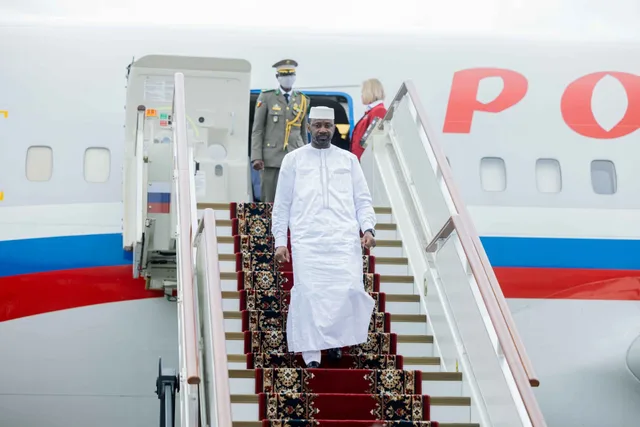 Mali's transitional president Assimi Goita, dressed in white, walks down the steps of a Russian aircraft, file photo