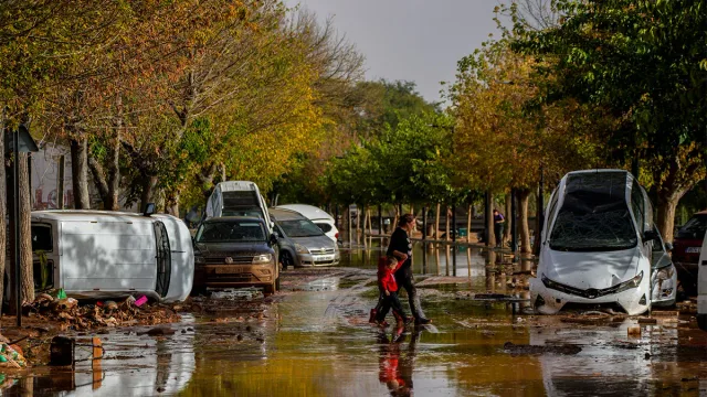 Damaged and overturned cars on a flooded, muddy street after the 2024 Valencia floods, file photo