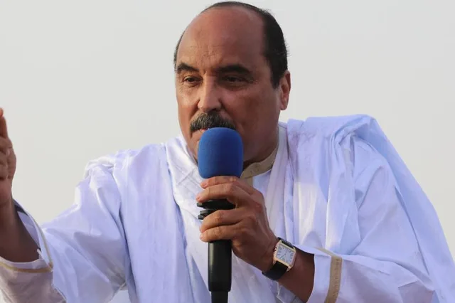 Former president Mohamed Ould Abdel Aziz speaking into a microphone