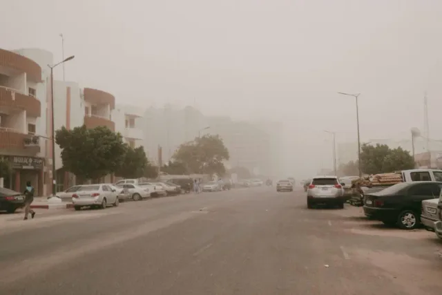 A Nouakchott street under a haze of dust with reduced visibility