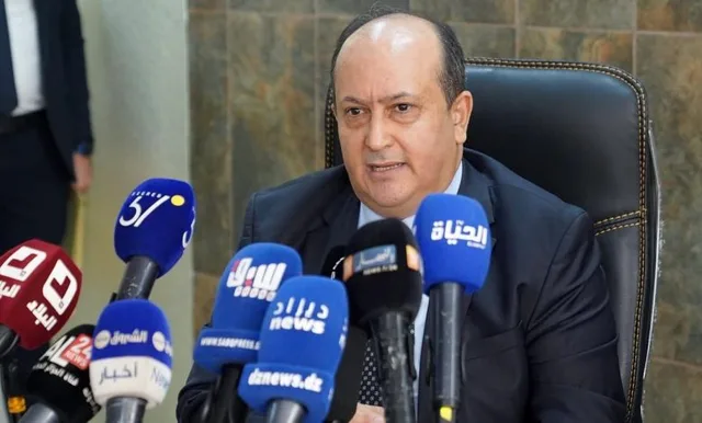 Algerian Prime Minister Sifi Ghrieb speaking in front of media microphones