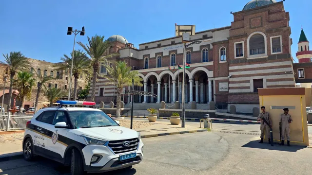 Facade of the Central Bank of Libya headquarters in Tripoli with a police car and two guards in front, file photo