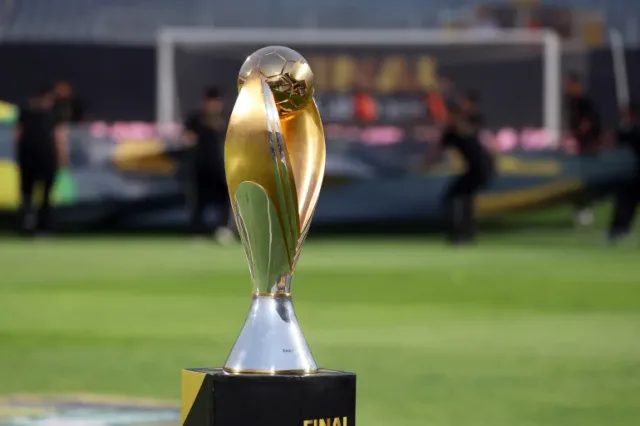 The gold and silver CAF Champions League trophy on a black plinth in a stadium before a final, file photo