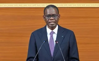 Senegalese Prime Minister Ahmadou Al Aminou Lo speaking at two microphones in parliament, file photo