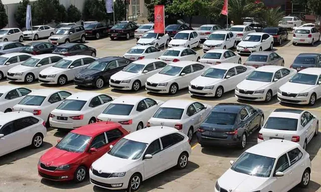 Rows of new cars parked in an open-air lot, file photo