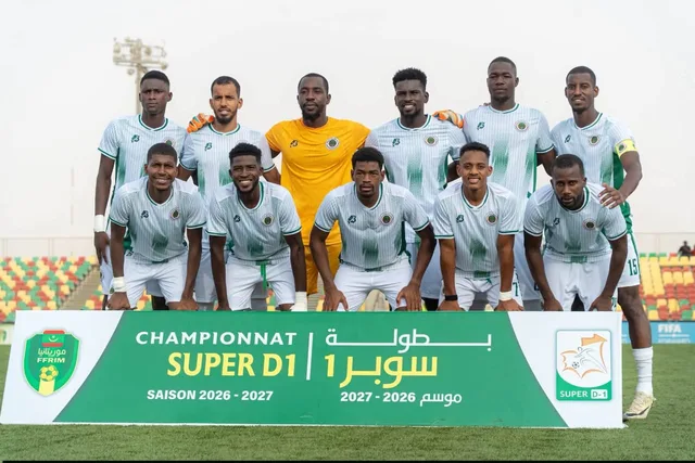 Players pose for a team photo in front of a Super D1 league banner