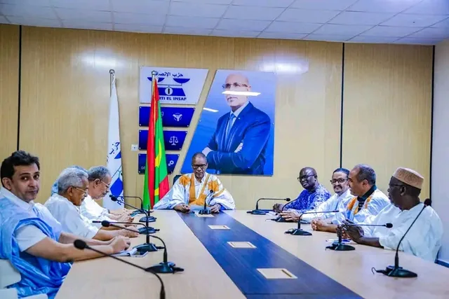 Officials seated around a table in a meeting room of the El Insaf party