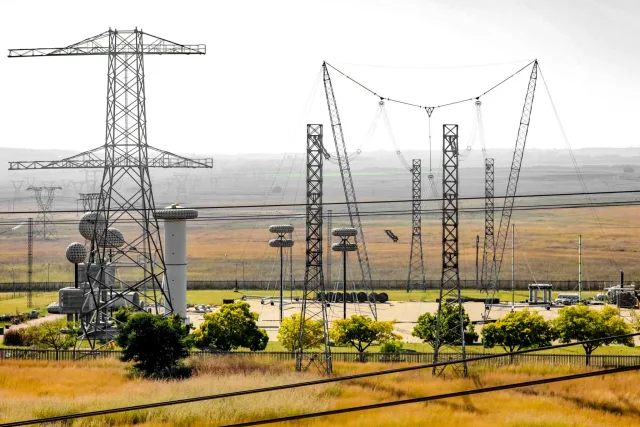 Pylons, power lines and a substation in a grassy landscape, illustrative image not related to Ukraine