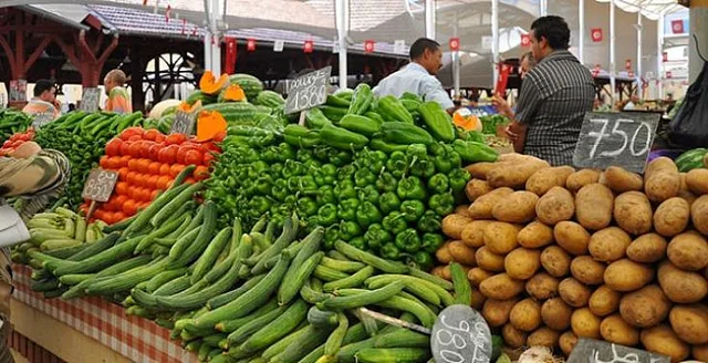A vegetable stall in a Tunisian market with peppers, courgettes, tomatoes and potatoes and price boards, file photo