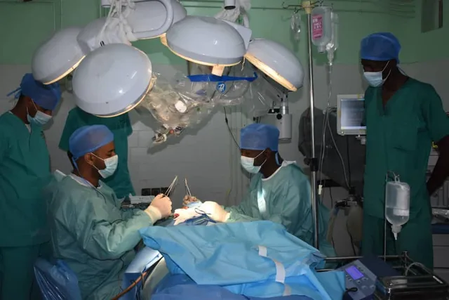 A medical team in surgical gowns operates in an operating theatre in Nouakchott