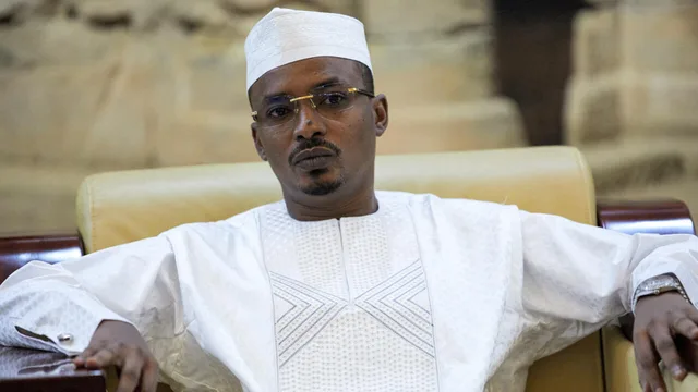 Chadian President Mahamat Idriss Deby, in white robe and white cap, seated in an armchair, file photo