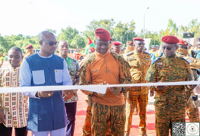 President Ibrahim Traore cuts an inauguration ribbon surrounded by civilian and military officials