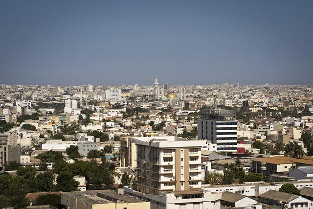 Elevated view of Dakar's white buildings with a golden mosque dome in the middle under a clear sky, file photo