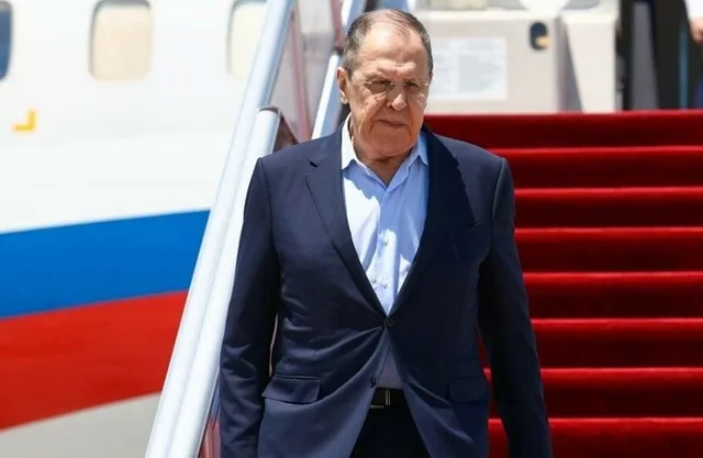 Russian Foreign Minister Sergey Lavrov steps off a plane onto a red carpet, file photo