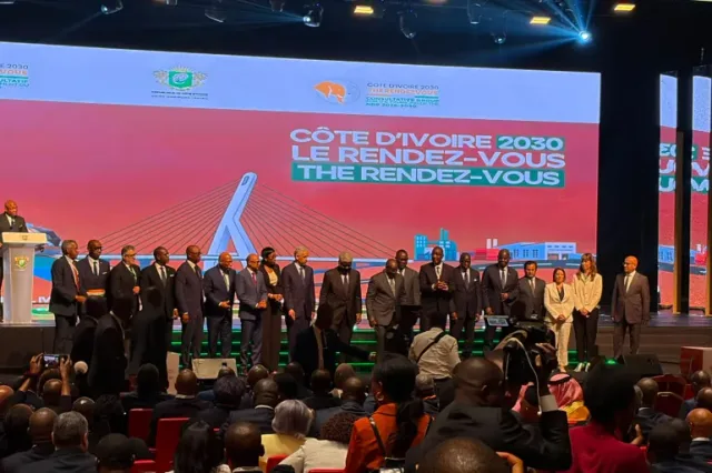 Officials on a stage in front of a screen reading Cote d'Ivoire 2030 during a meeting in Abidjan, file photo
