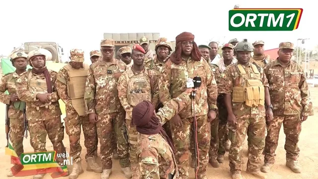 Malian military personnel speaking to microphones