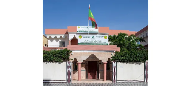 Facade of the National Human Rights Commission headquarters with its sign and the national flag