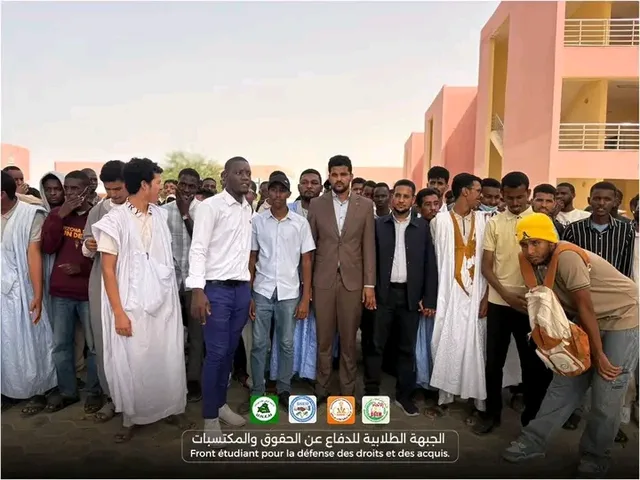 A group of students posing outside a university building