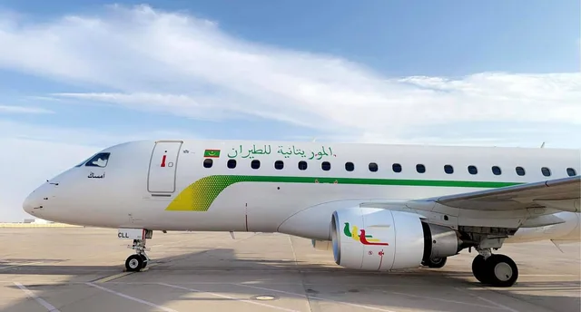 A white Mauritania Airlines aircraft on an airport apron