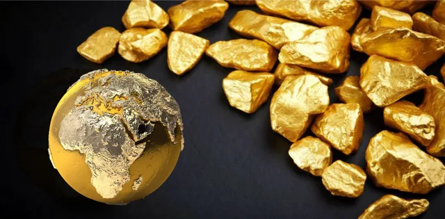 Gold nuggets on a black background next to a golden globe, file illustration