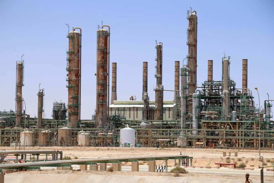 Refining columns and tanks at a Libyan oil facility under a clear sky, file photo