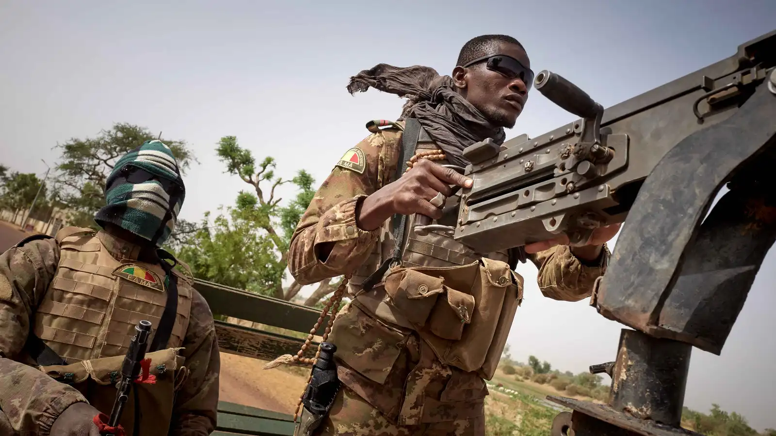Malian soldiers on a military vehicle mounted with a machine gun