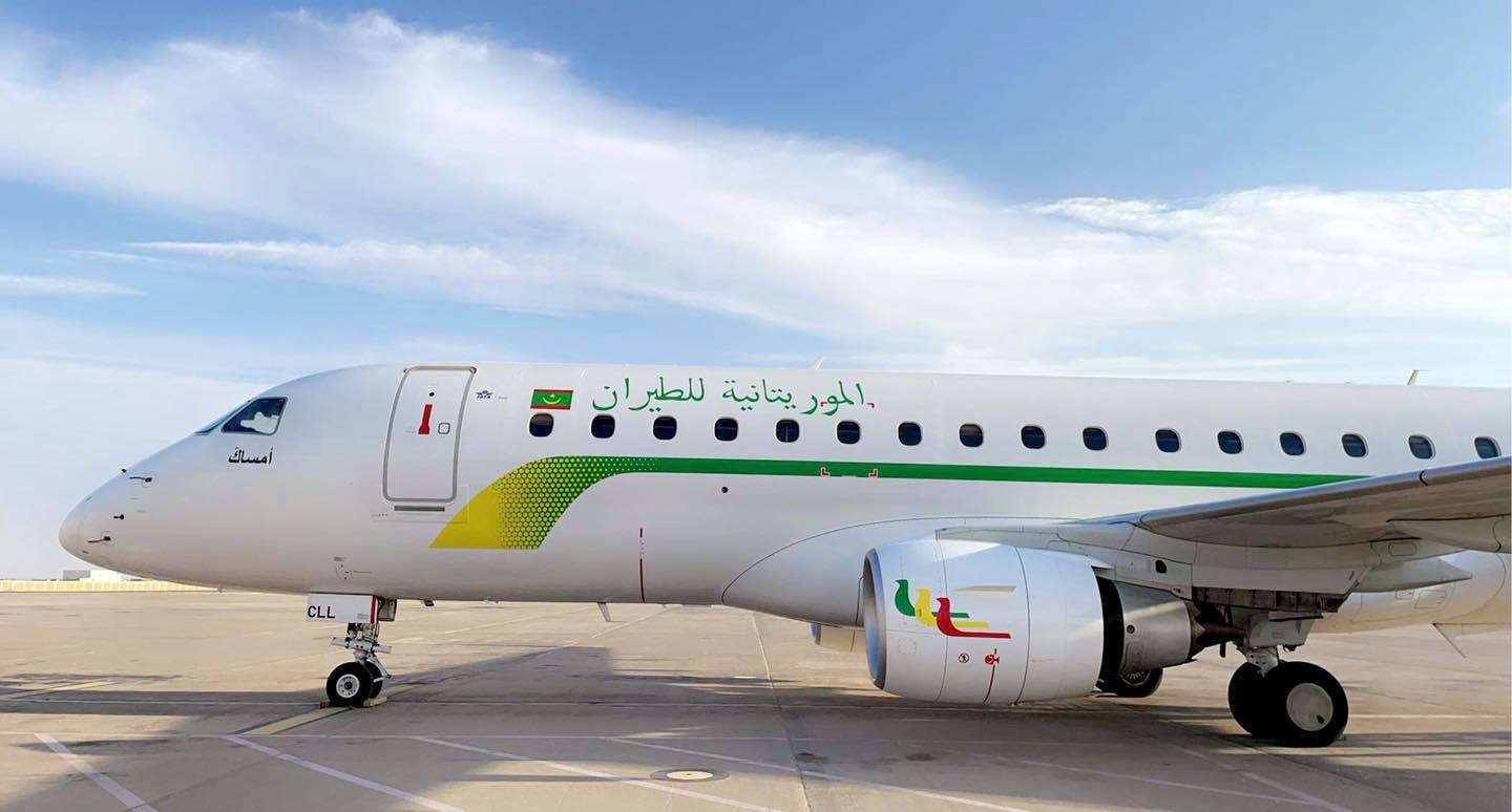 A white Mauritania Airlines aircraft on an airport apron