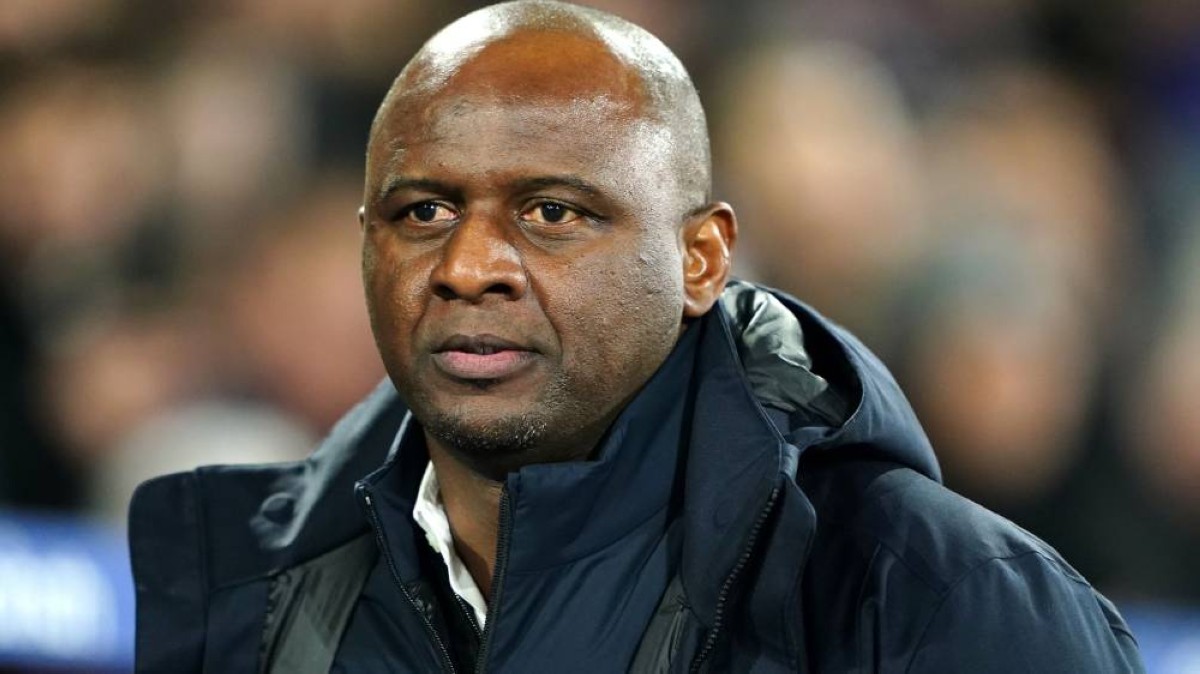 Patrick Vieira in a dark jacket at a football ground