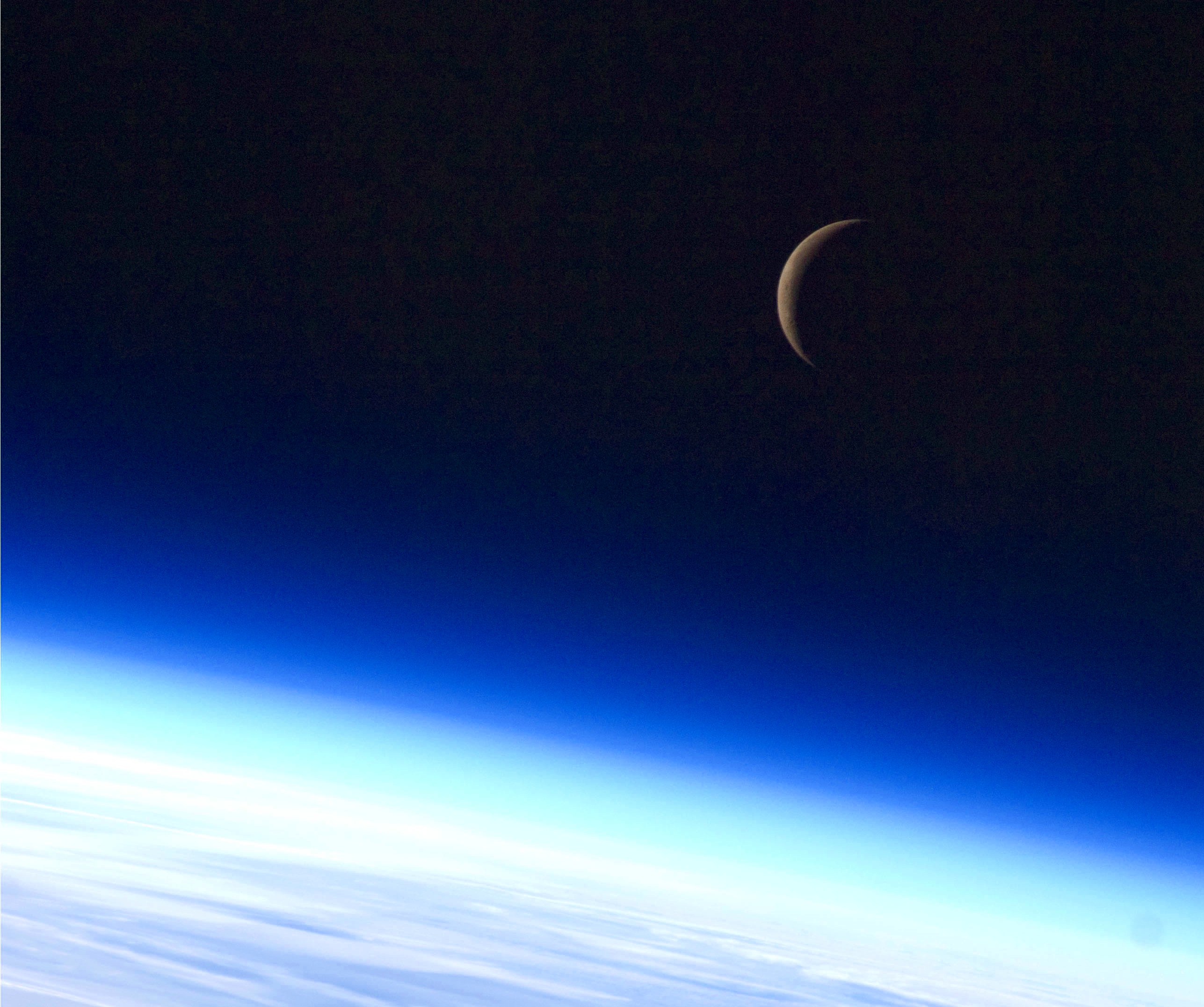 Archival NASA photograph of a crescent Moon from the International Space Station in 2010, not the October 2026 observation in Mauritania.