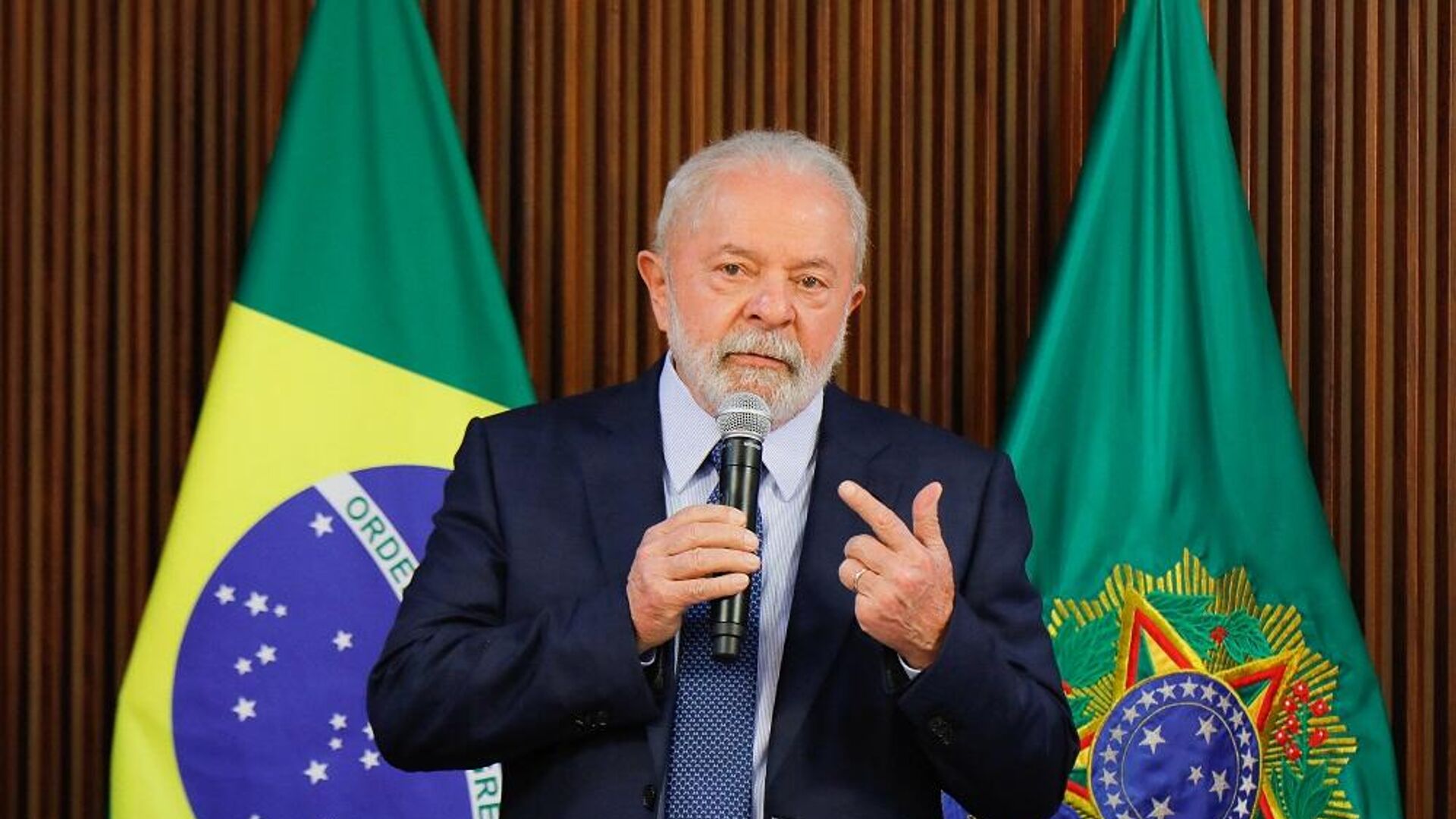 Brazilian President Lula da Silva speaks into a microphone in front of two Brazilian flags, file photo
