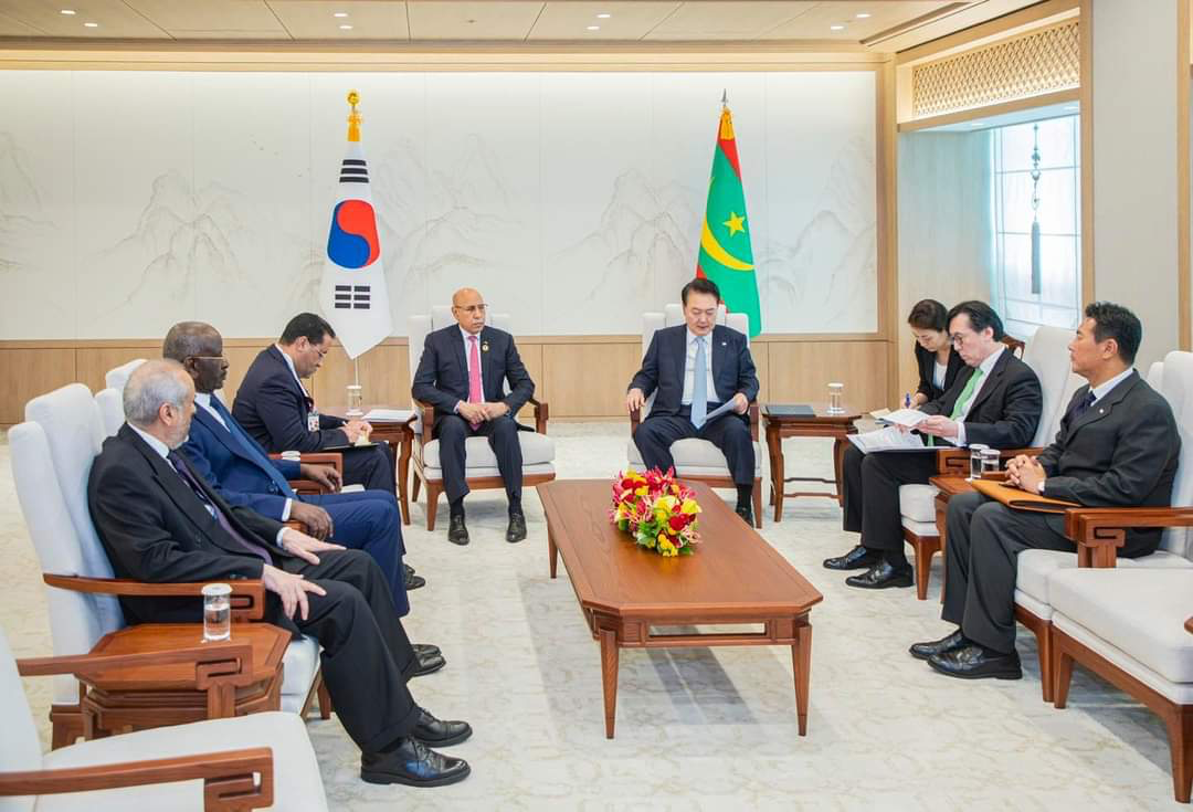 Then South Korean President Yoon Suk-yeol and President Mohamed Ould Cheikh El Ghazouani seated with their delegations before both countries' flags in Seoul, file photo