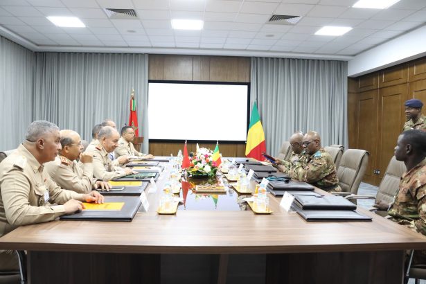 Moroccan and Malian officers around a meeting table in front of both countries' flags