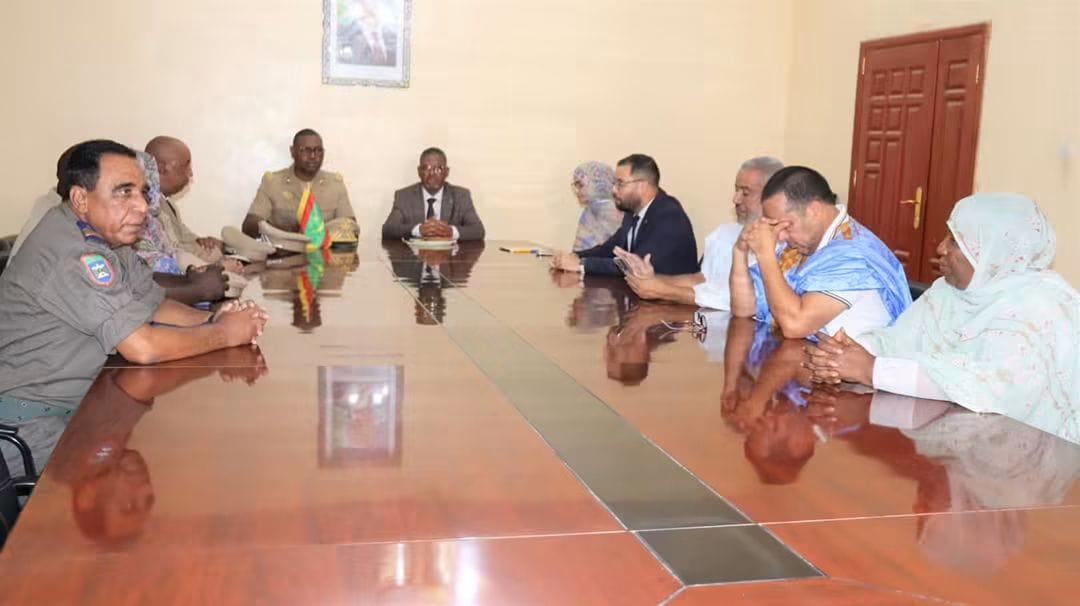 Officials around a meeting table in an administrative office