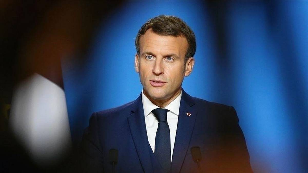 French President Emmanuel Macron speaking at microphones against a blue background, file photo
